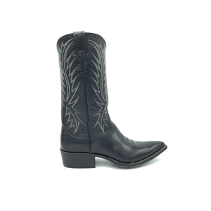 Authentic custom women's cowboy boots from the 1960's. Black cowhide leather with white stitch. Traditional western toe medallion. 12" height. 1 1/2" heel. Pointed toe. Black leather sole. These one-of-a-kind unworn Nocona cowboy boots were handmade in Nocona, Texas. Proudly made in the USA.