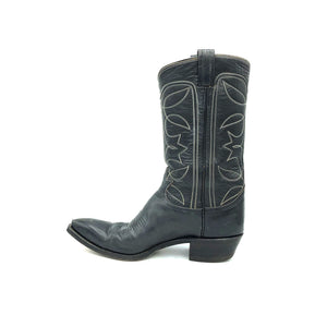 Authentic custom women's cowboy boots from the 1970's. Black cowhide leather with white stitch. Traditional western toe medallion. 11" height. 1 1/2" heel. Pointed toe. Black sole. These one-of-a-kind Tony Lama's were handmade in El Paso, Texas. Proudly made in the USA.