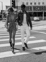 Stylish couple just passing Tower Records on Sunset Blvd wearing vintage cowboy boots.