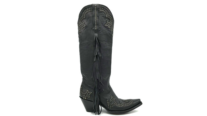 Joplin Fringe is a handmade women's tall cowboy boot. Supple black cowhide leather with brass studded vamp and uppers. Side seams of soft black fringe. Pointed toe and traditional western heel. Black leather lining.