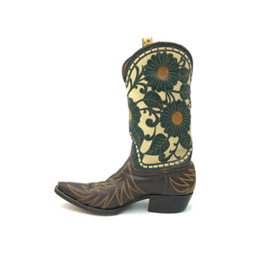 Authentic custom men's cowboy boots. Brown cowhide leather on vamp with tan flame stitch. Light beige tops with forest green floral overlays with mustard yellow stitch. Chocolate brown braided collar. Light beige braided backseam. Inside chocolate brown leather pull-straps. 12" height. 1 1/4" heel. Snip toe. Brown leather sole. These Liberty cowboy boots were handmade in Mexico.