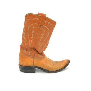 Authentic custom men's cowboy boots from the 1960's. Cognac cowhide leather with multi-color stitch. Traditional western toe medallion. 11" height. 1 1/4" heel. Pointed toe. Brown sole. These one-of-a-kind Tony Lama's were handmade in El Paso, Texas. Proudly made in the USA.
